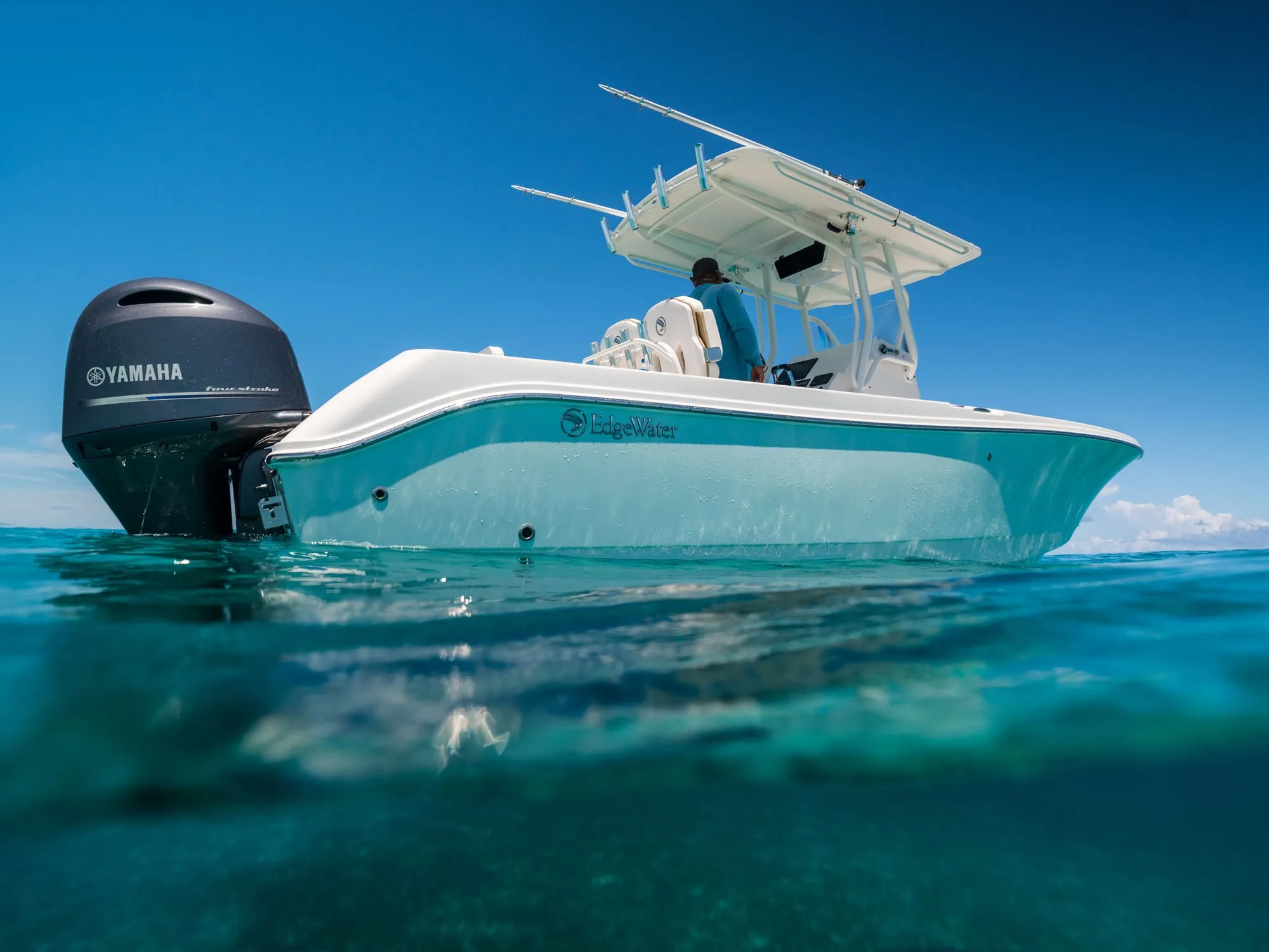 Angler fighting a kingfish on an EdgeWater 245CC in the Great Barrier Reef.